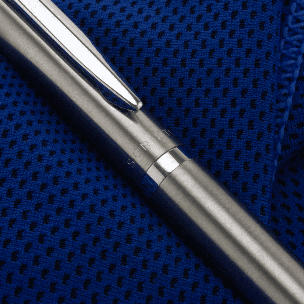 A sleek metallic ballpoint pen in a black gift box, featuring a polished silver clip and a textured grip.