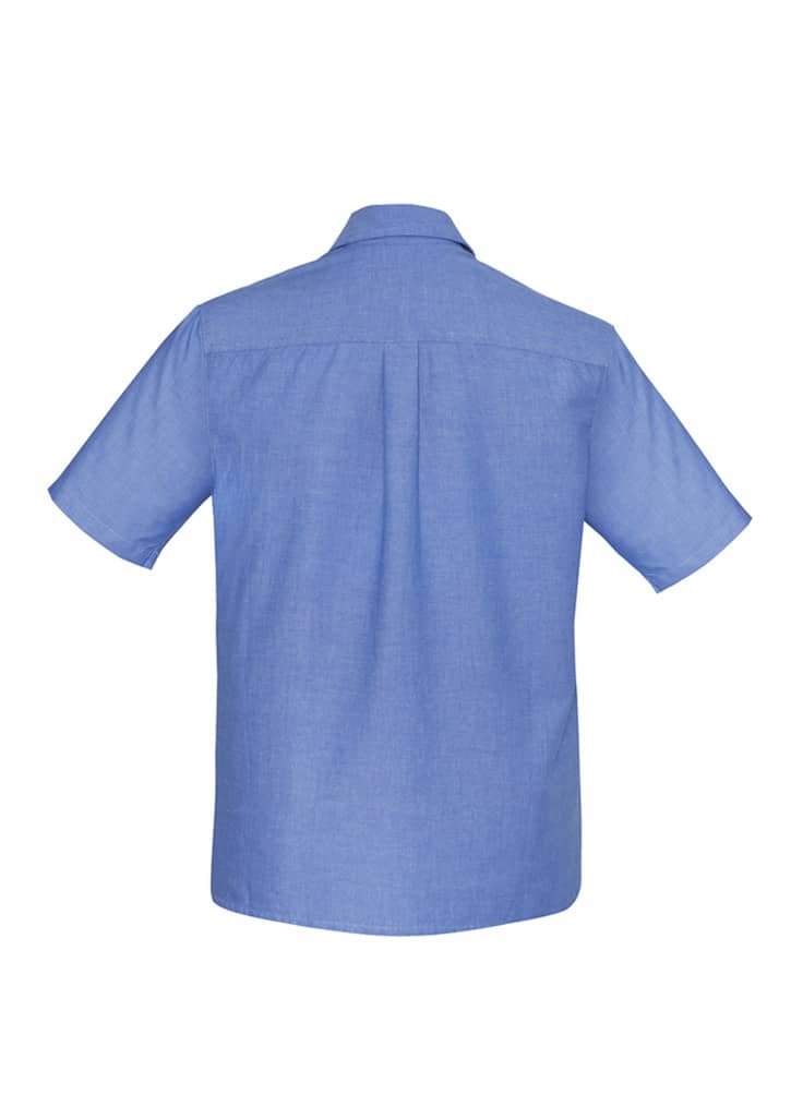 A blue men's chambray short sleeve shirt with a button-up design and a back yoke. Features a logo.
