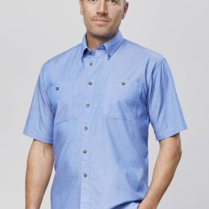 A blue chambray short-sleeve button-up shirt with two front pockets and a logo on the chest.
