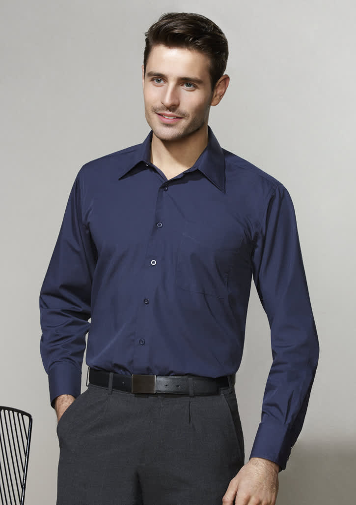 A navy blue long sleeve button-up shirt on a model, featuring a collar and a logo on the chest.
