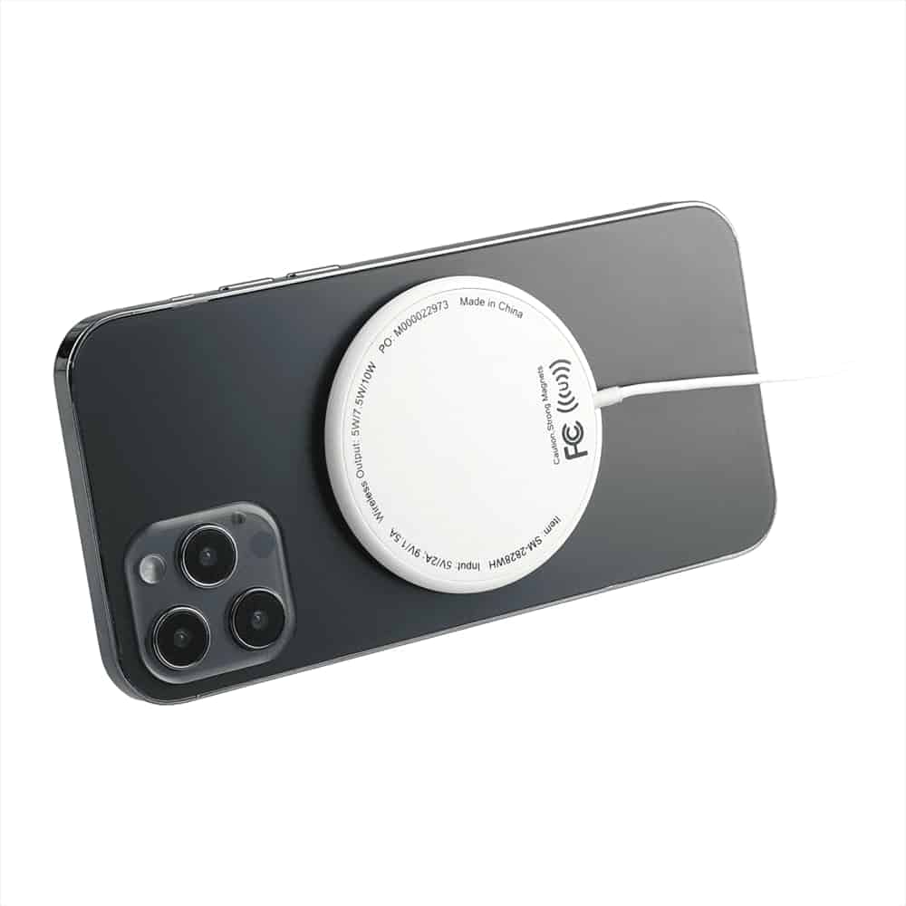 A white MagClick Fast Wireless Charging Pad attached to a dark smartphone, with a charging cable connected.