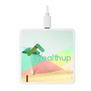 A square white wireless charging pad featuring a beach scene with a logo and pastel colours.