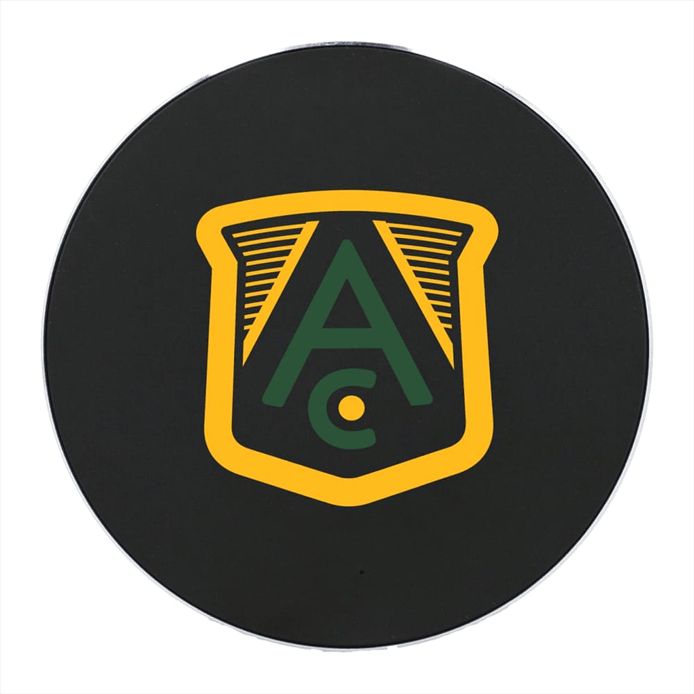 A round wireless charging pad in black featuring a logo with green and yellow elements.