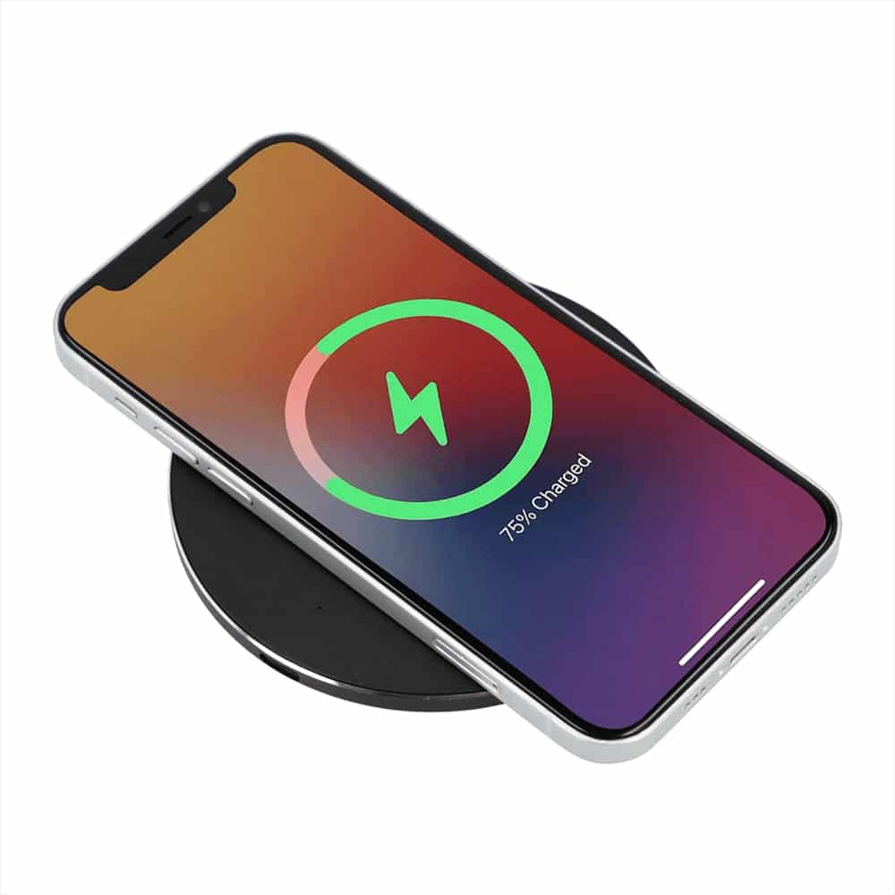 A black wireless charging pad with a smartphone displaying a charging status indicator.