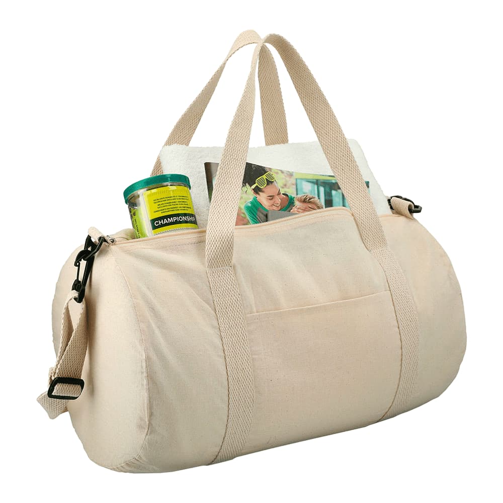 A light beige barrel duffel bag featuring two handles, a shoulder strap, and an external pocket with items inside.