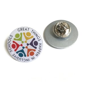 A stainless steel lapel pin featuring a colourful circular design and a silver backing.