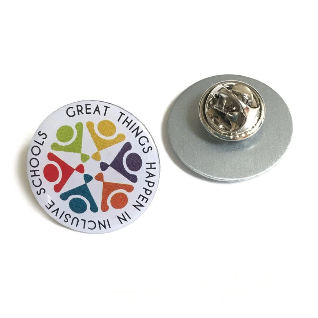 A stainless steel lapel pin featuring a colourful circular design and a silver backing.