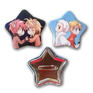 Three star-shaped button badges featuring colourful animated designs, including characters in playful poses. One has a shiny silver back.