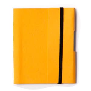 A small yellow tuck journal book with a black elastic band. It features a smooth cover and a side pocket.