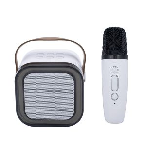 A portable karaoke machine in white with a square speaker and a microphone, featuring a handle for easy transport.