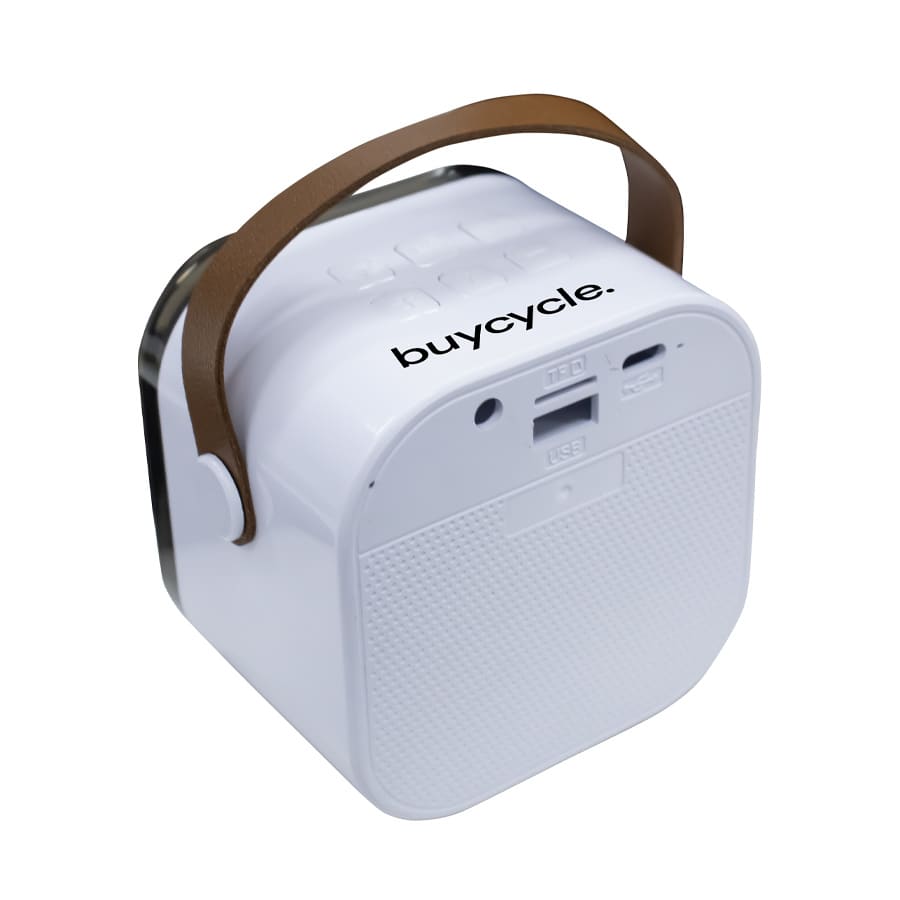 A white portable karaoke machine with a brown handle, featuring various buttons and ports, and displaying a logo.