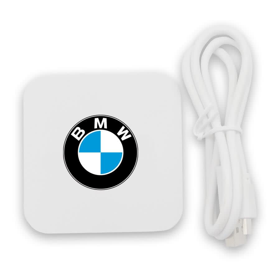 A white wireless charging dock with a logo and a white charging cable.