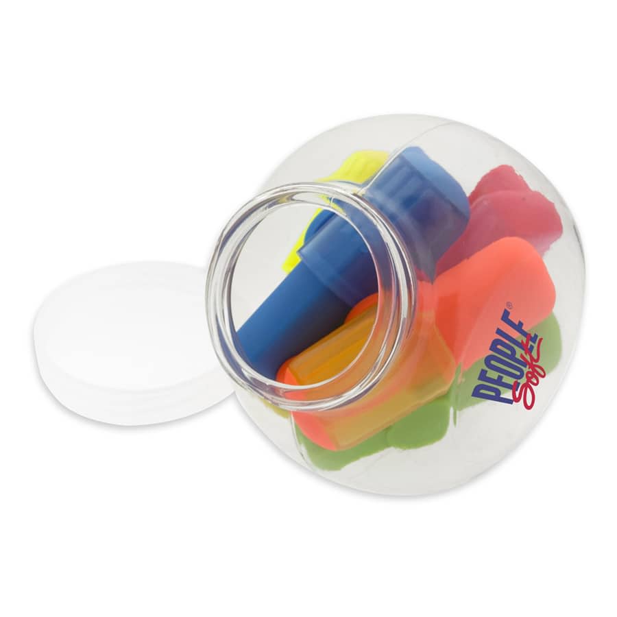 A transparent jug contains assorted highlighters in bright colours, including blue, pink, yellow, and orange.