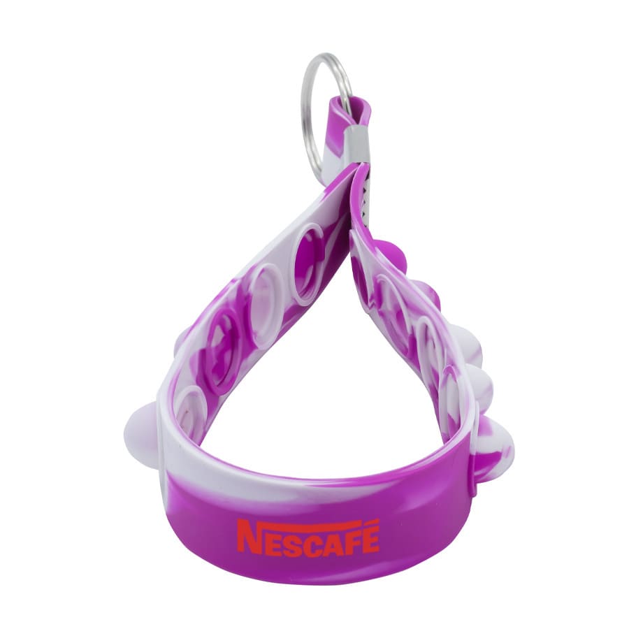A purple and white Popper Stress Reliever Key Chain with a circular design and a metal keyring.