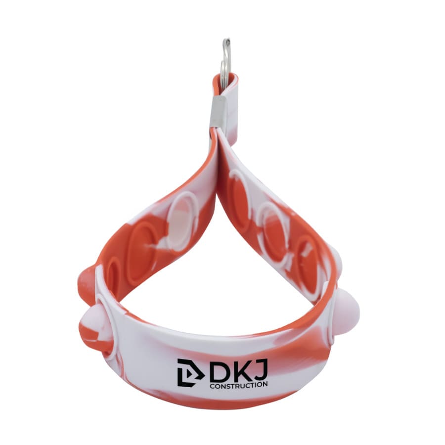 A red and white silicone stress reliever keychain with multiple poppable sections and a metal keyring.