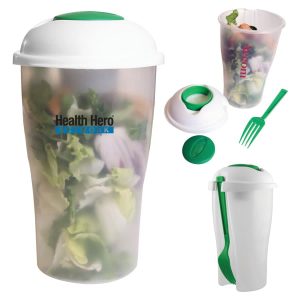 A clear salad shaker with a white lid and green accents, featuring a fork and a compartment for utensils.