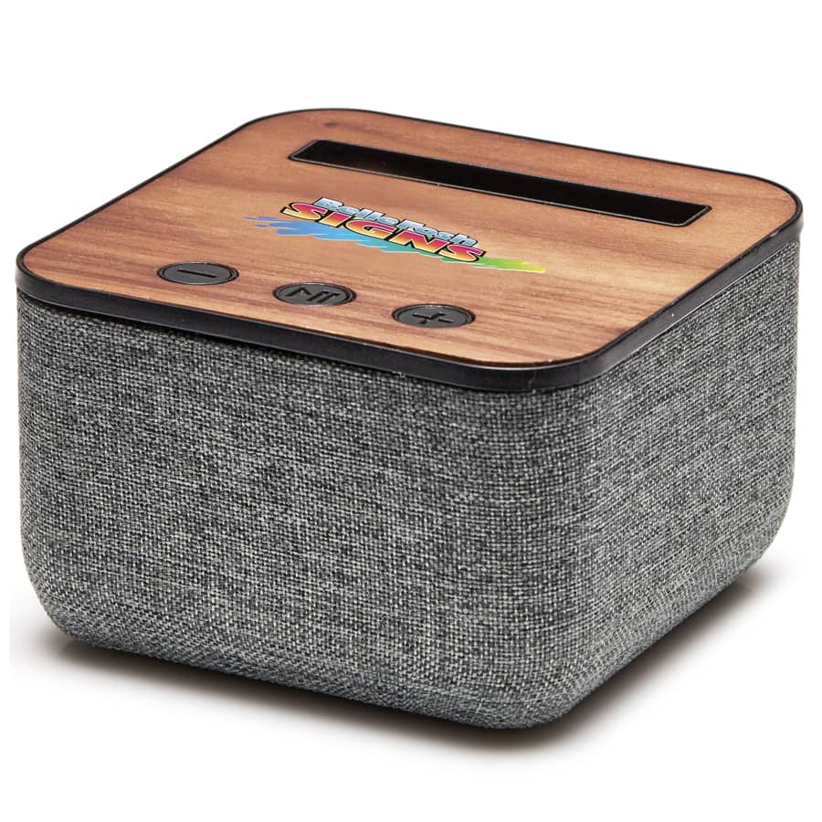 A Bluetooth speaker with a wooden top and grey fabric body, featuring control buttons and a logo.