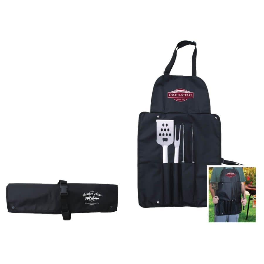 A black BBQ set featuring a spatula, fork, and tongs, neatly rolled into an apron-style holder. Includes a logo.