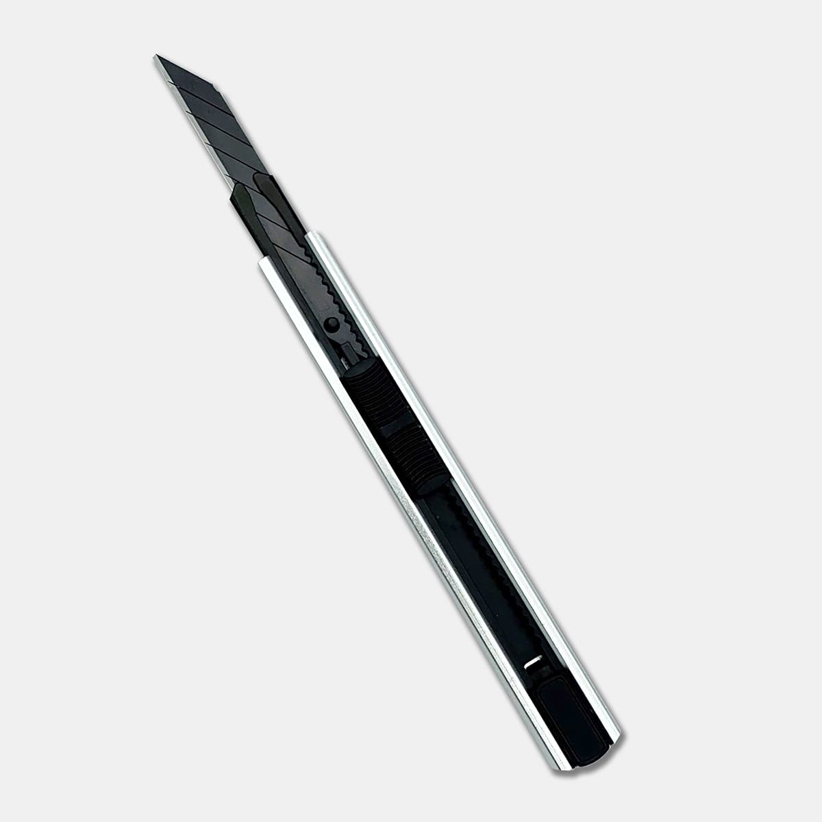 A silver and black slimline retractable box cutter with a sleek design and a visible blade.