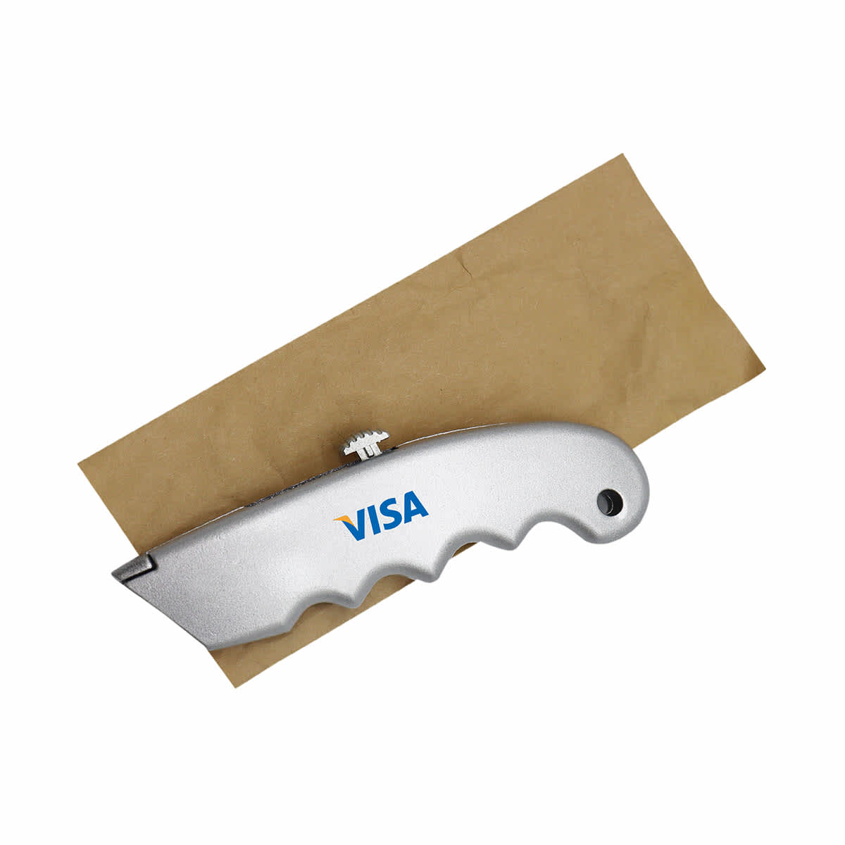 A silver cutter with a textured grip, resting on a piece of brown paper. The cutter features branding.