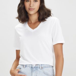 A white women's short sleeve t-shirt with a V-neck design, featuring a model wearing it with light blue denim.