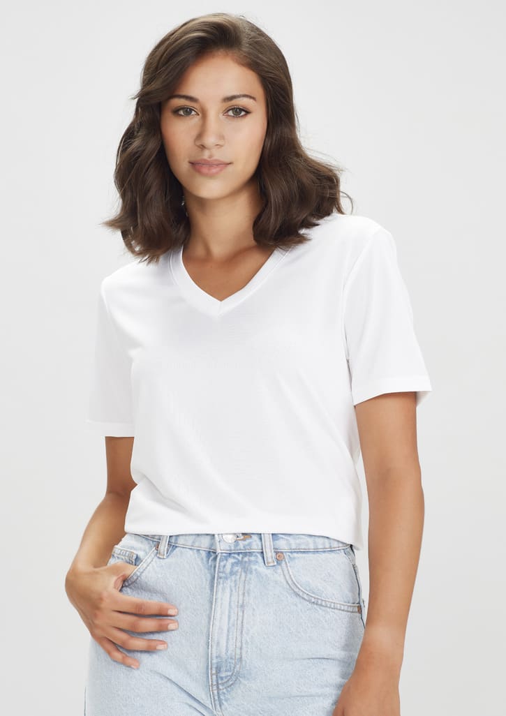 A white women's short sleeve t-shirt with a V-neck design, featuring a model wearing it with light blue denim.