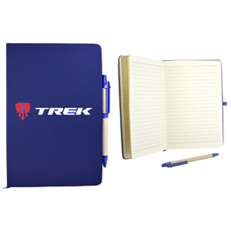 A navy blue recycled notebook with lined pages, accompanied by a blue pen, features a logo on the cover.