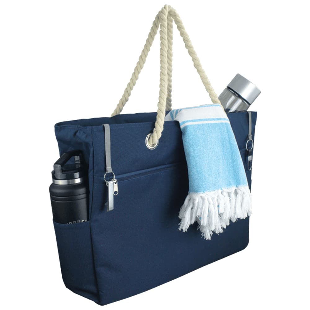 A navy waterproof beach bag with a rope handle and an external pocket for a drink bottle. It has a logo.