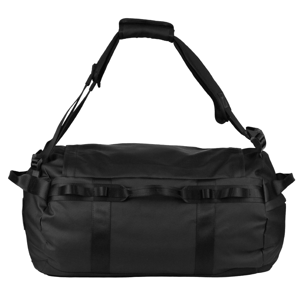 A black duffel bag with sturdy straps and textured detailing, being held by a person.