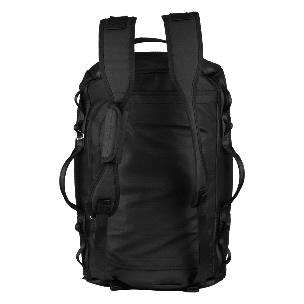 A black duffel bag is worn on one shoulder by a person in a casual outfit, set against a building backdrop.