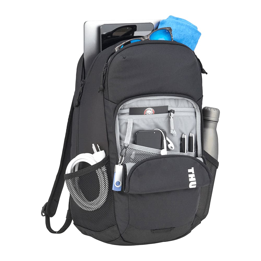 A black Thule Achiever 15 laptop backpack featuring zippered pockets and mesh side panels. It has a logo on the front.