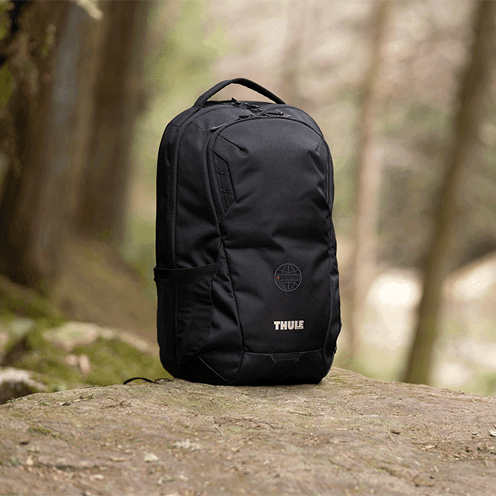 A black backpack with structured design, featuring a logo, suitable for carrying laptops and other items.