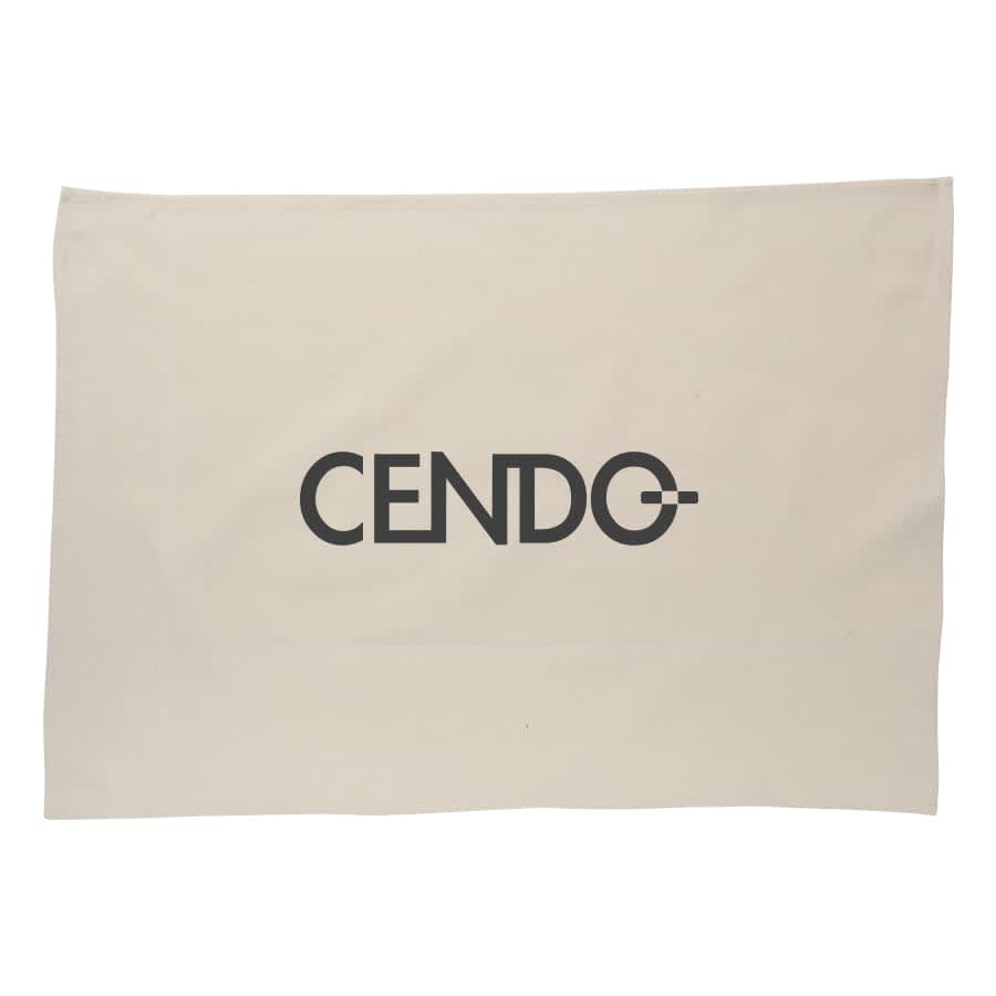 A cream cotton tea towel featuring a large black logo in the centre.