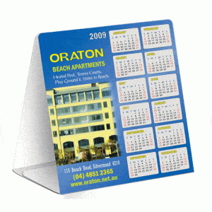 A table tent featuring a blue design, displaying a calendar for 2009 with a logo and an image of a building.