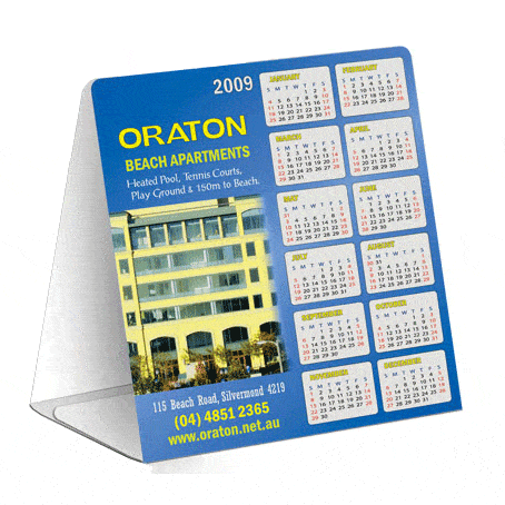 A table tent featuring a blue design, displaying a calendar for 2009 with a logo and an image of a building.