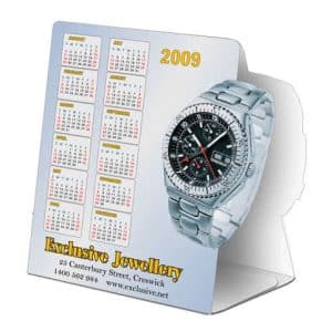 A table tent featuring a silver watch and a calendar for the year 2009, with a logo at the bottom.