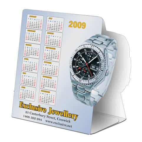 A table tent featuring a silver watch and a calendar for the year 2009, with a logo at the bottom.