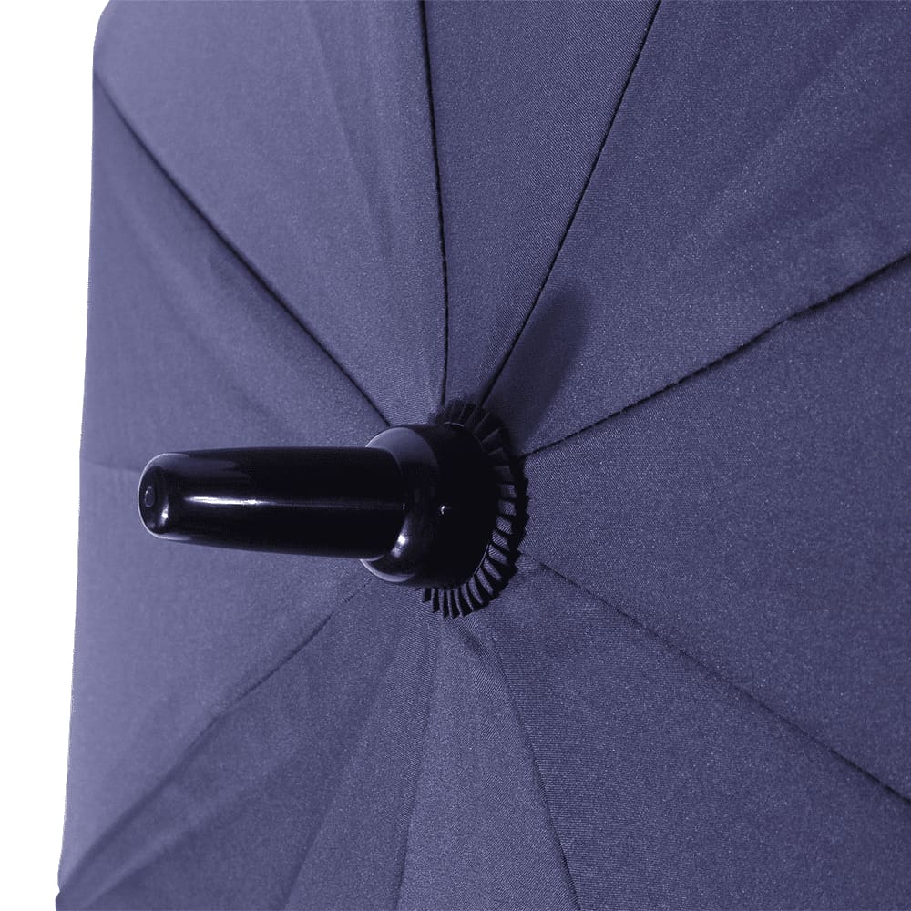 A close-up of the corner of a navy blue vented tipless golf umbrella featuring a structured design.