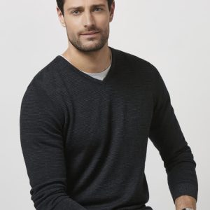 A black Merino pullover sweater is displayed being worn by a man, featuring a V-neck and long sleeves.