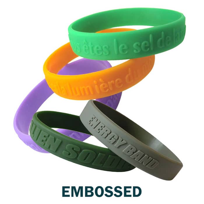 A collection of embossed silicone wristbands in green, orange, purple, and grey, featuring various designs and a logo.