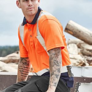 An orange short sleeve polo shirt with shoulder tape detail, worn by a tattooed man sitting outdoors.