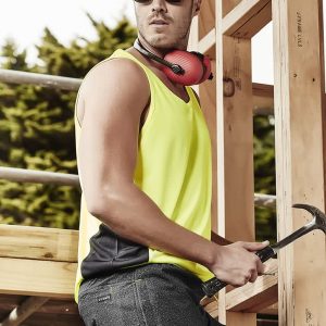 A man wearing a bright yellow hi-vis singlet and sunglasses, holding a hammer, with a construction backdrop.