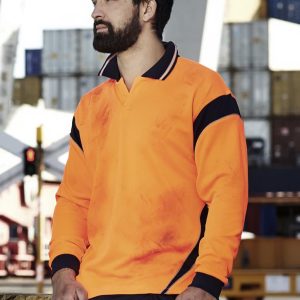 A long sleeve polo shirt in bright orange with navy accents, featuring a logo and worn by a man at a worksite.