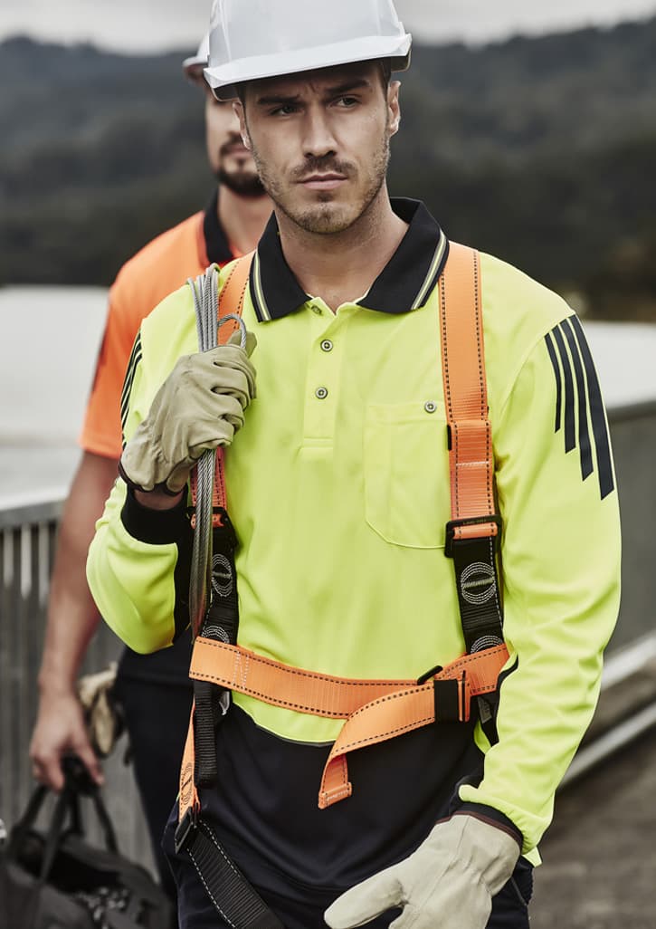 A men's hi-vis long sleeve polo in bright yellow and navy, featuring safety harness and gloves, with a logo.
