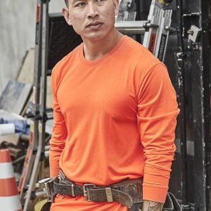 An orange long sleeve tee with a fitted design, suitable for safety wear, worn by a man on a construction site.