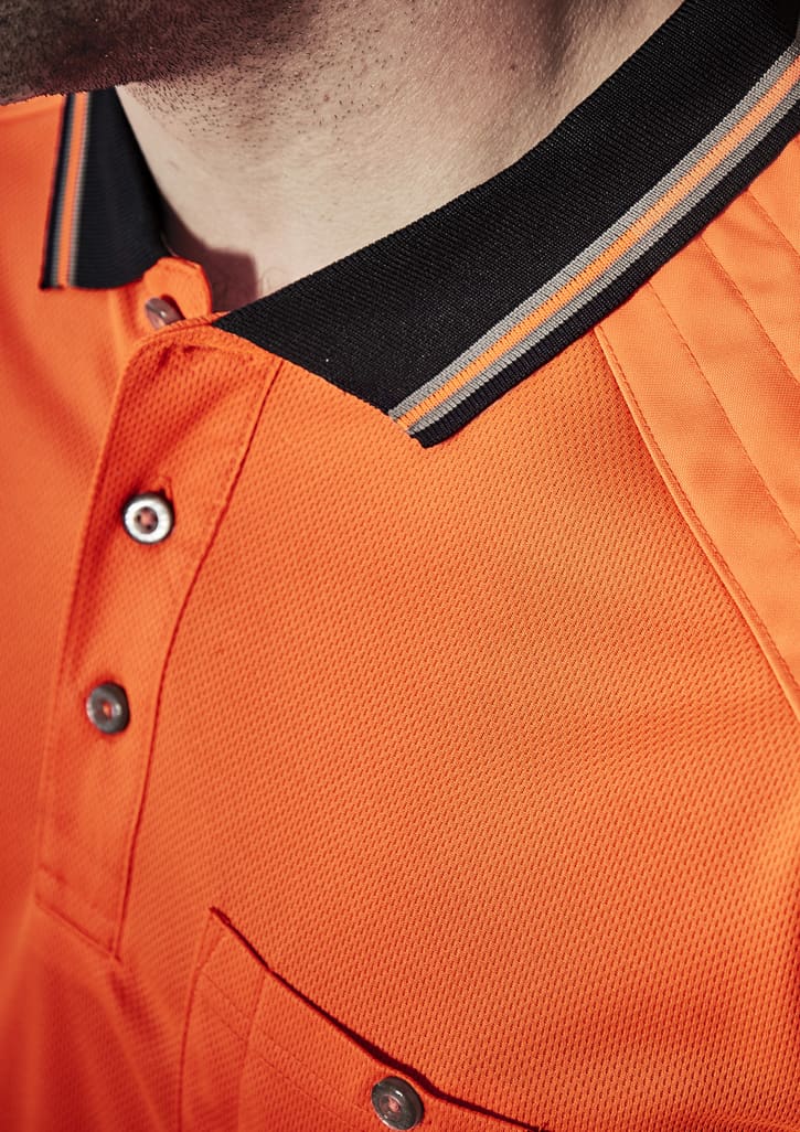 A close-up of an orange short sleeve polo shirt with a black collar and a logo. Features a pocket and buttons.
