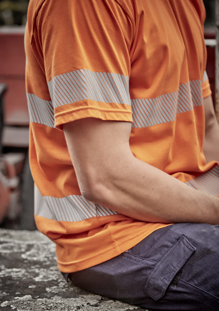A men's short-sleeve hi-vis orange cotton tee with segmented reflective tape on the sleeves, featuring a relaxed fit.