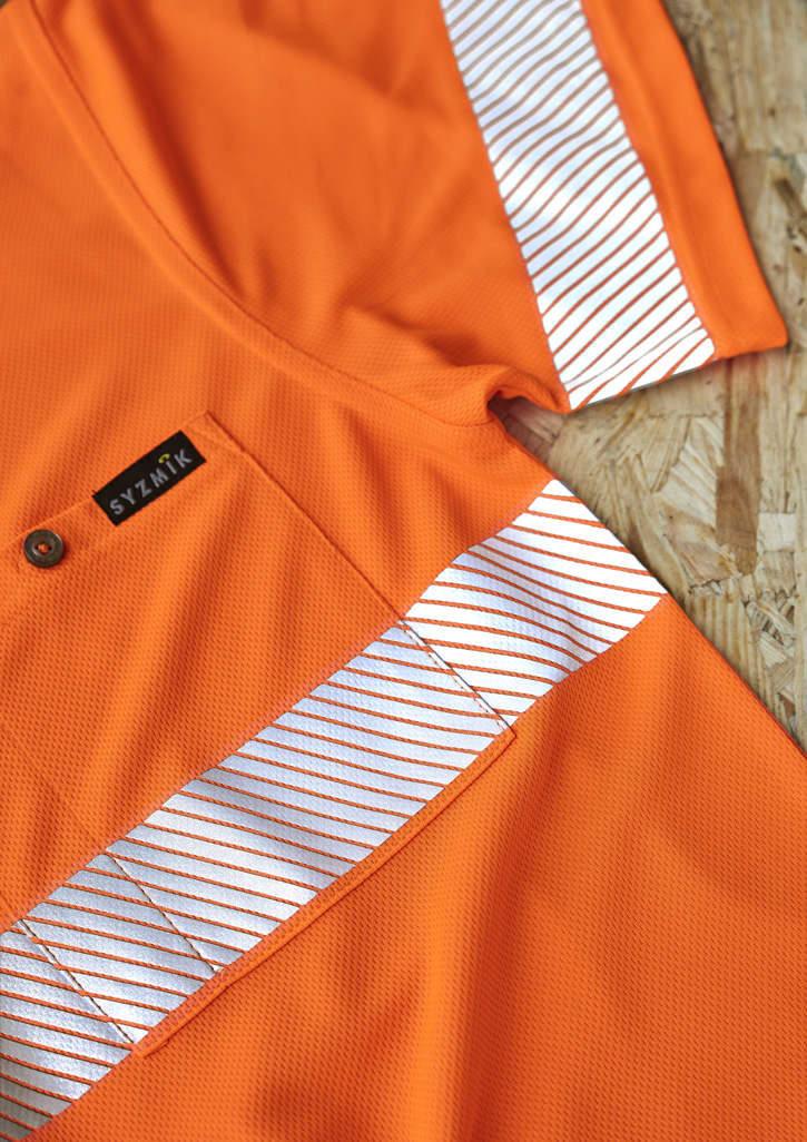 An orange short sleeve polo shirt featuring segmented reflective tape and a logo. The material appears breathable and mesh-like.