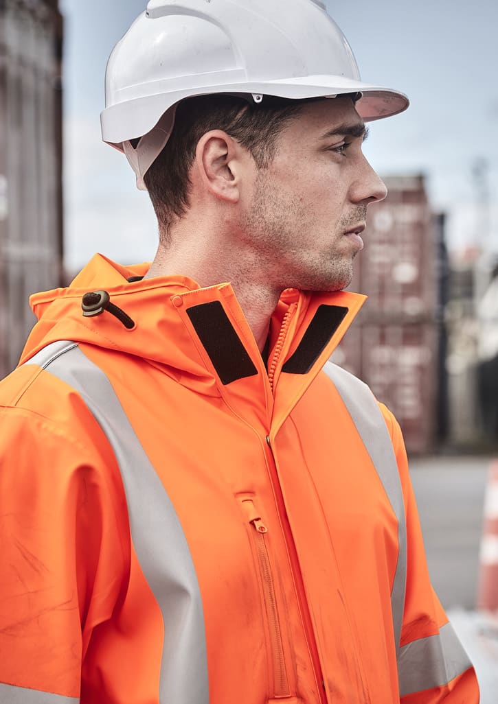 An orange heavy-duty waterproof jacket with reflective strips, worn by a person in a hard hat.