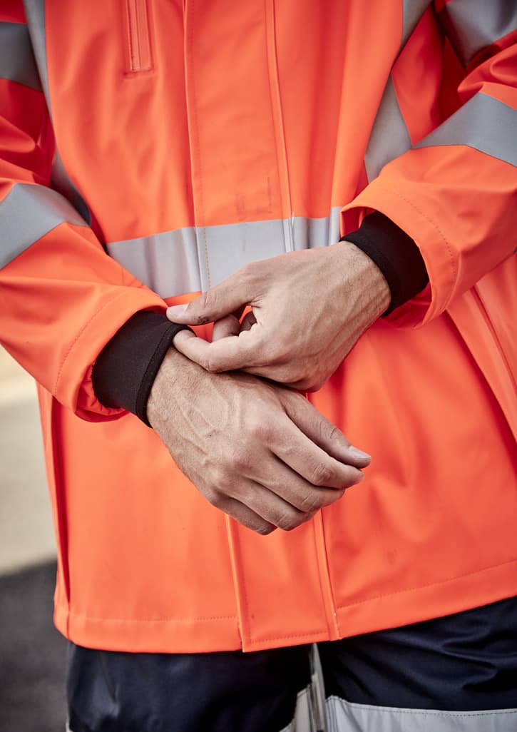 A heavy-duty waterproof jacket in bright orange with reflective stripes, featuring black cuffs. There is a logo on the jacket.